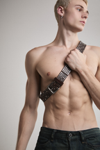 Close-up view of Tyler Andersen holding brown AOA belt with rivets.