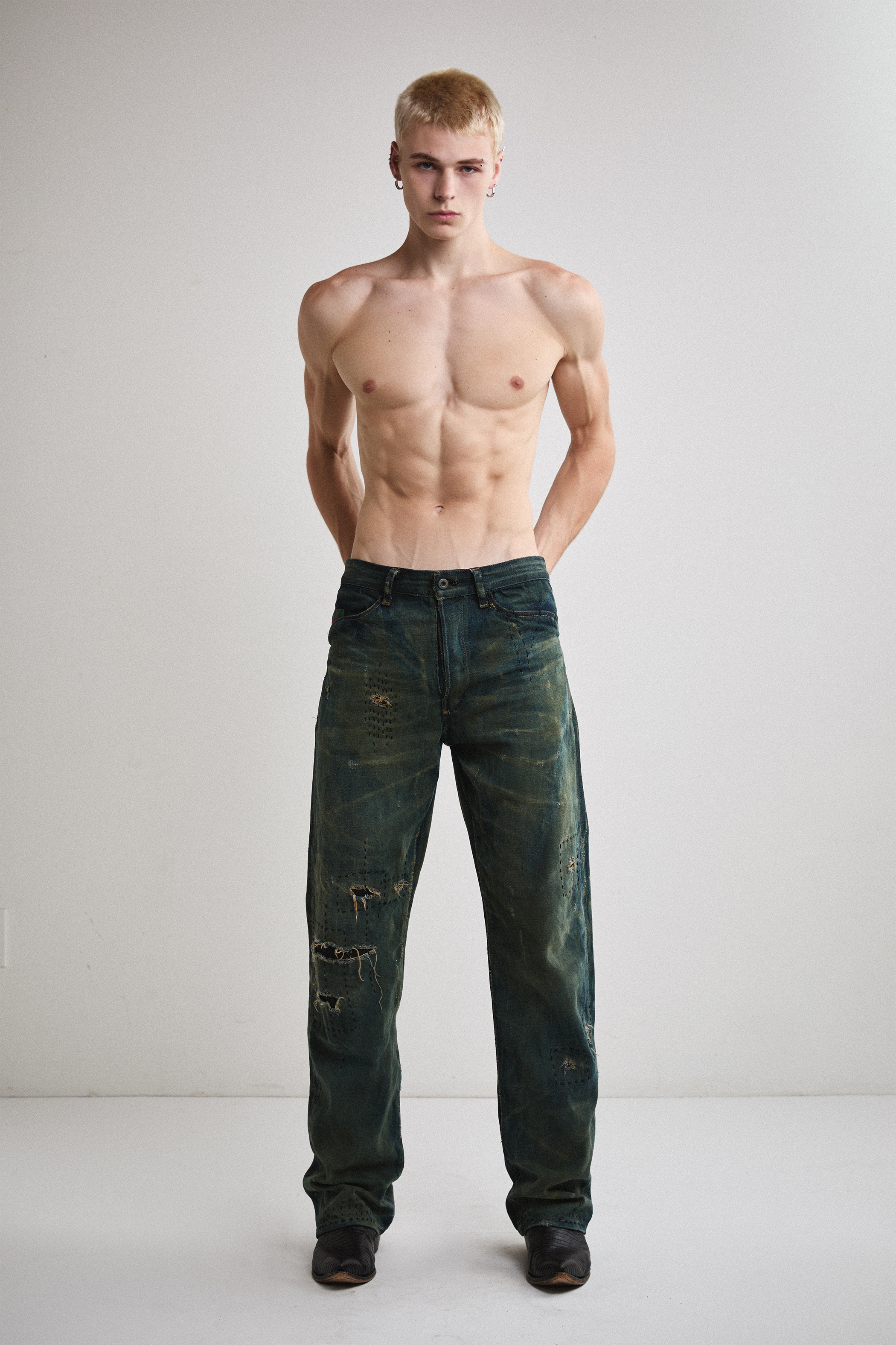 Front view of Tyler Andersen wearing distressed AOA Sashiko repaired denim