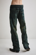 Close-up back view of Tyler Andersen wearing distressed AOA Sashiko repaired denim