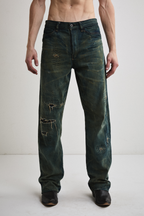 Close-up front view of Tyler Andersen wearing distressed AOA Sashiko repaired denim