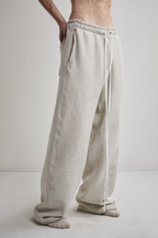 Close-up side view of Tyler Andersen wearing AOA heavyweight grey sweats.