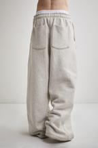 Close-up back view of Tyler Andersen wearing AOA heavyweight grey sweats.