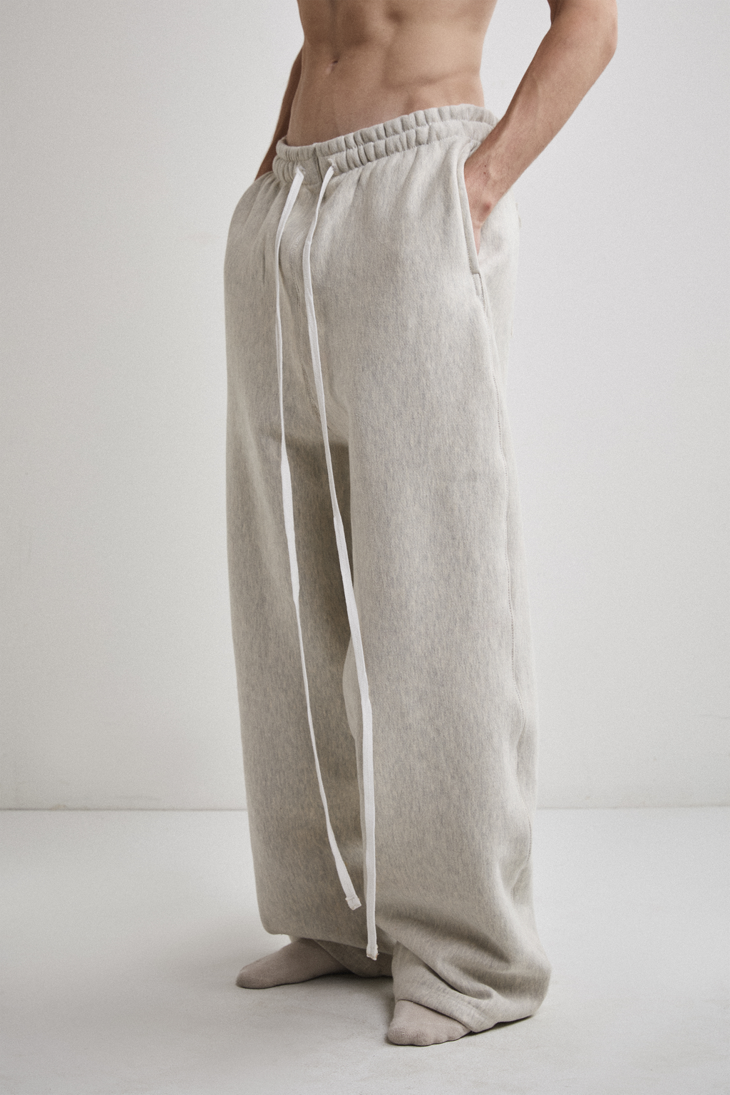 Close-up left side view of Tyler Andersen wearing AOA heavyweight grey sweats.