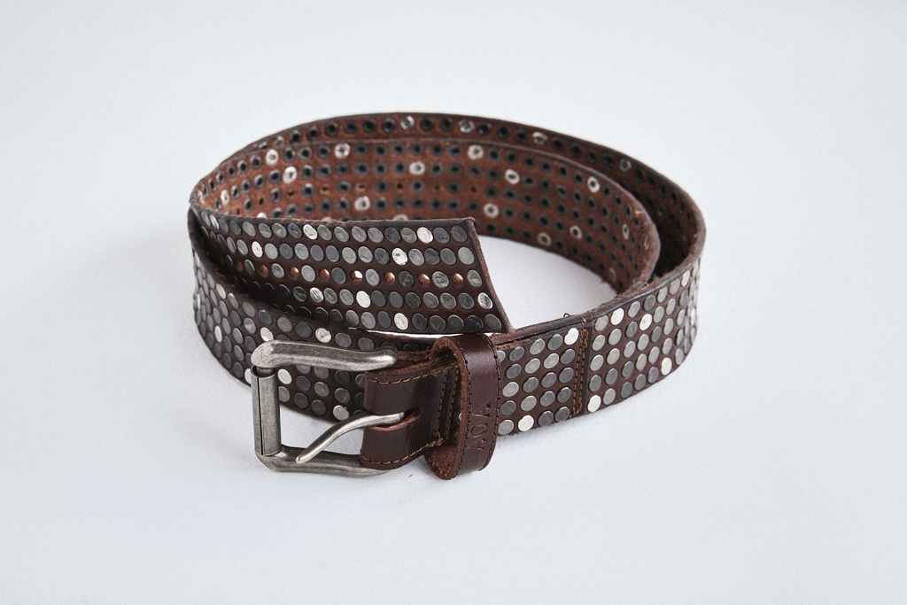 Close-up view of brown AOA belt with rivets in circle shape.