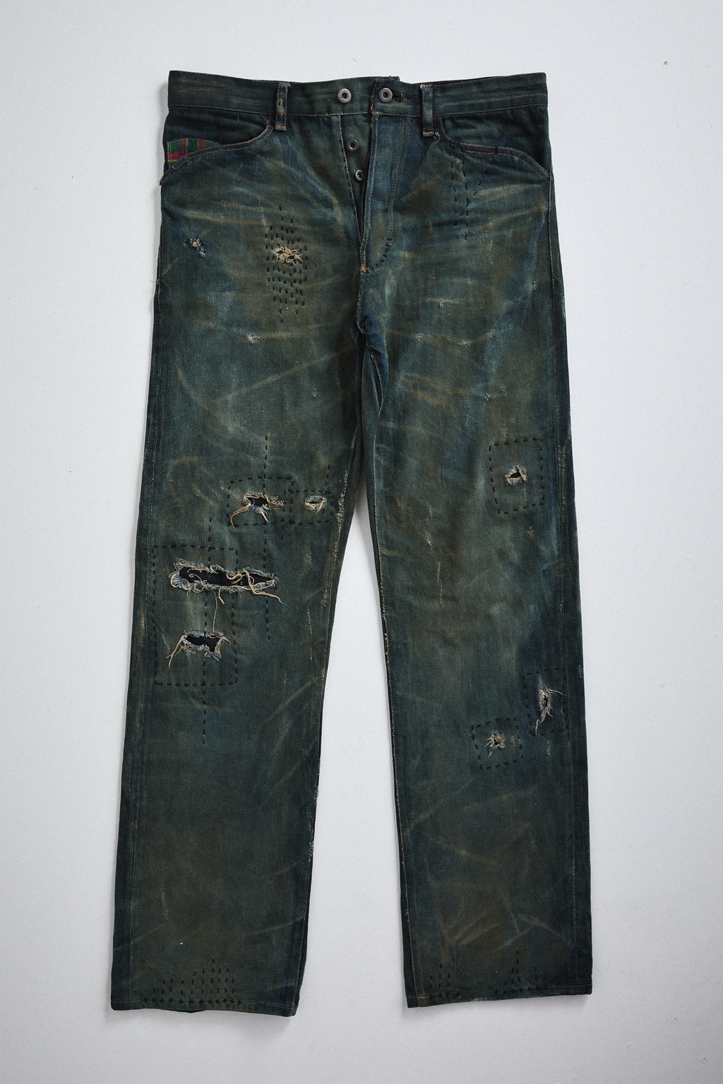 Front view of distressed AOA Sashiko repaired denim