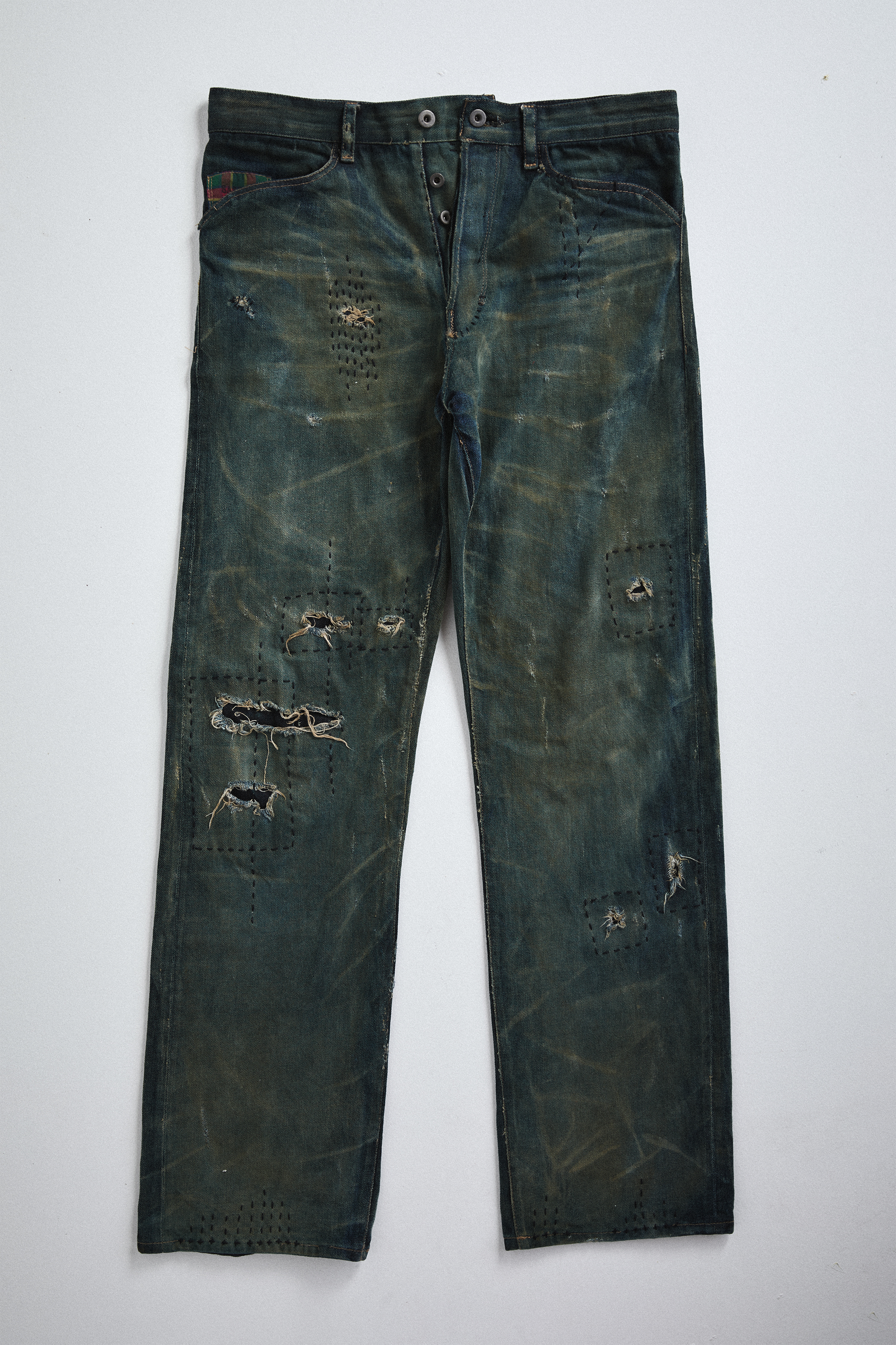 Front view of distressed AOA Sashiko repaired denim