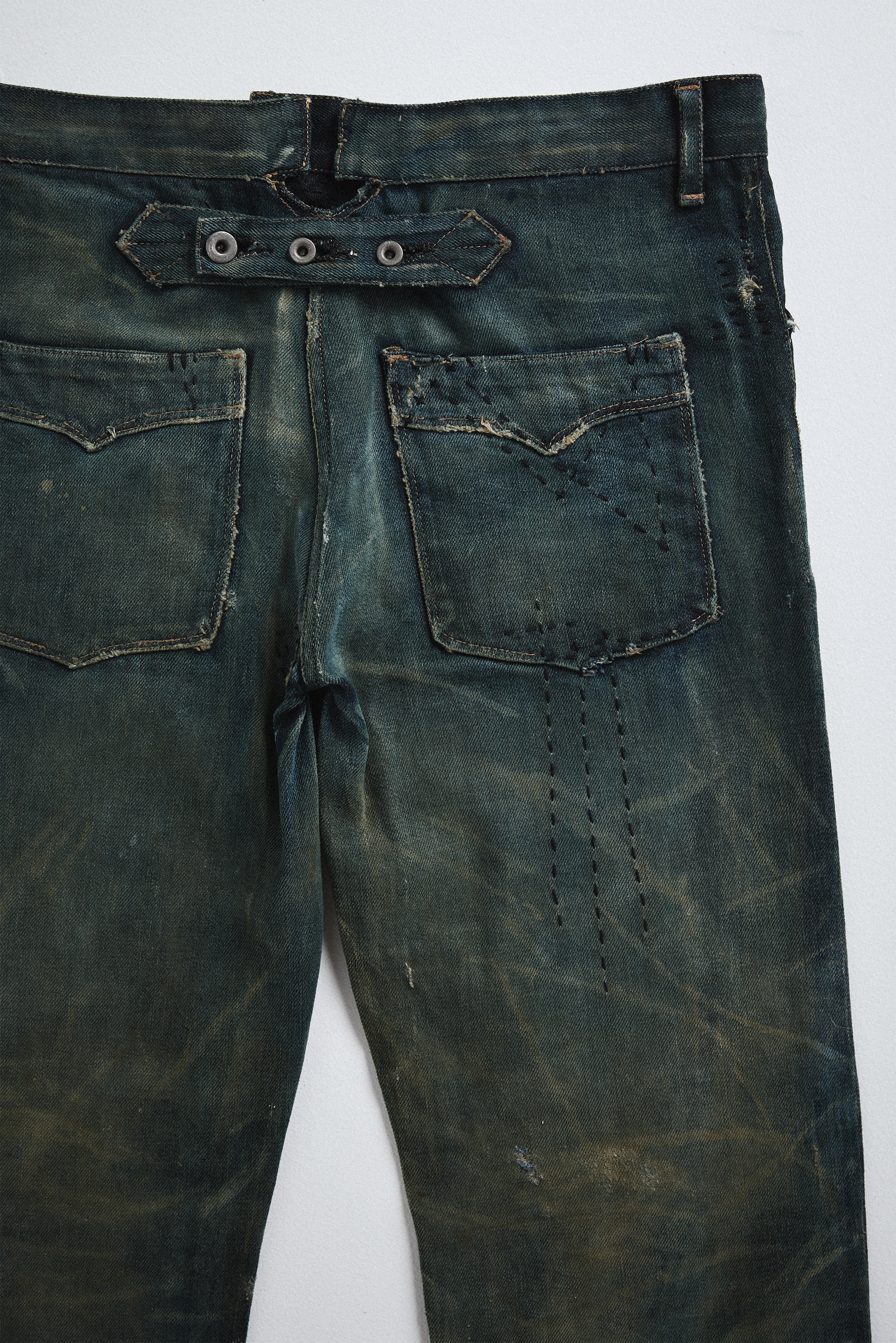 Close-up back view of distressed AOA Sashiko repaired denim