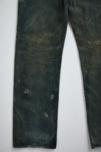 Ultra close-up front view of distressed AOA Sashiko repaired denim showing lower leg stitching details