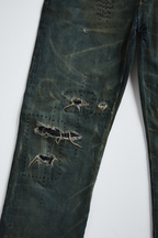 Ultra close-up front view of distressed AOA Sashiko repaired denim showing knee stitching details