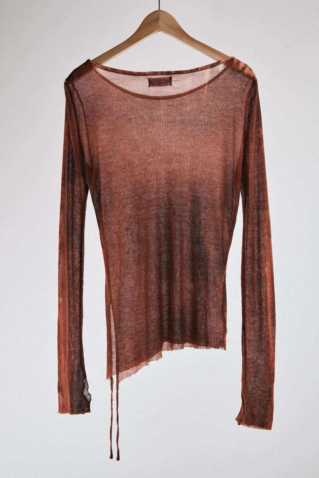 Front view of sheer long-sleeve AOA rust top with tassels.