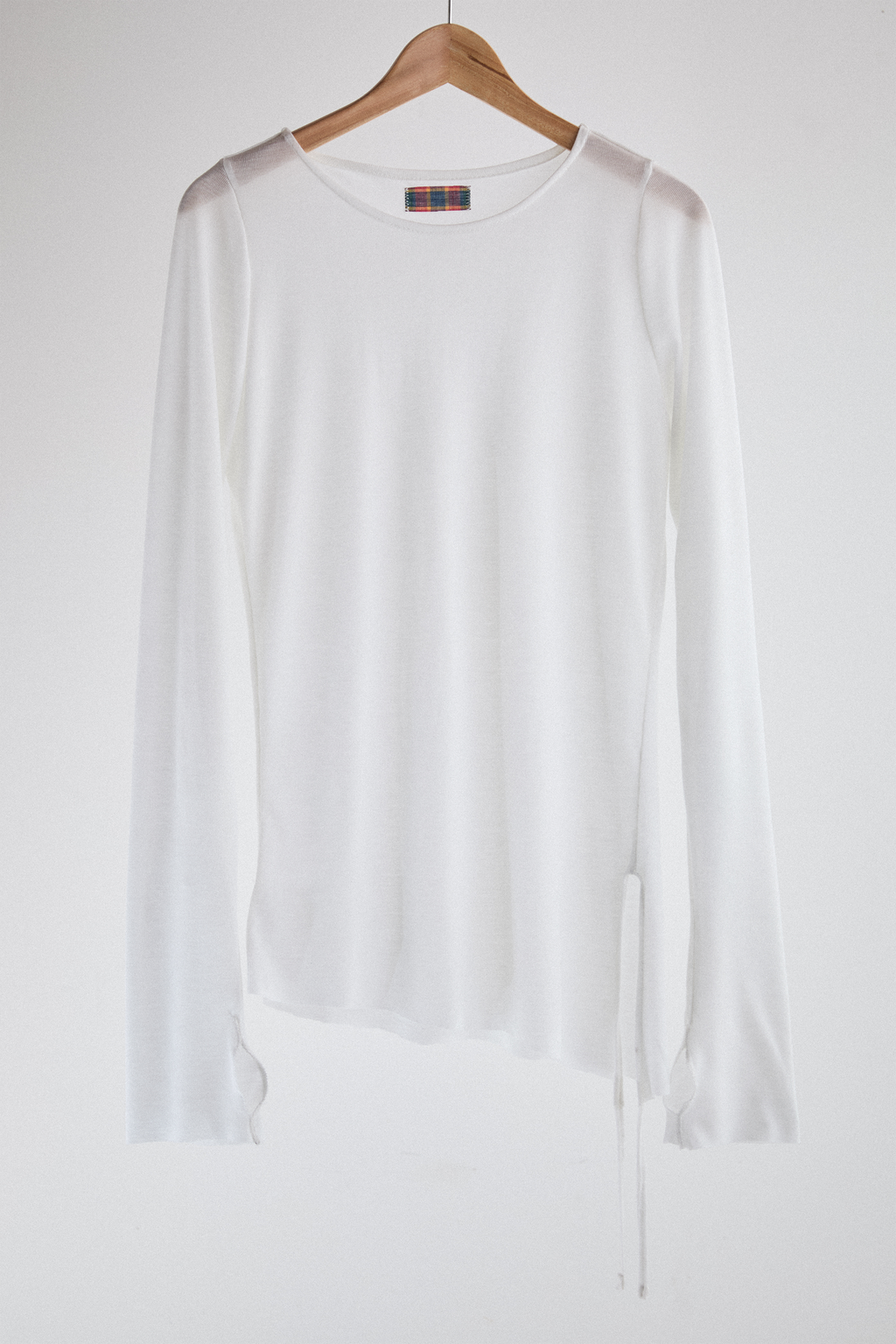 Front view of sheer long-sleeve AOA White  top.