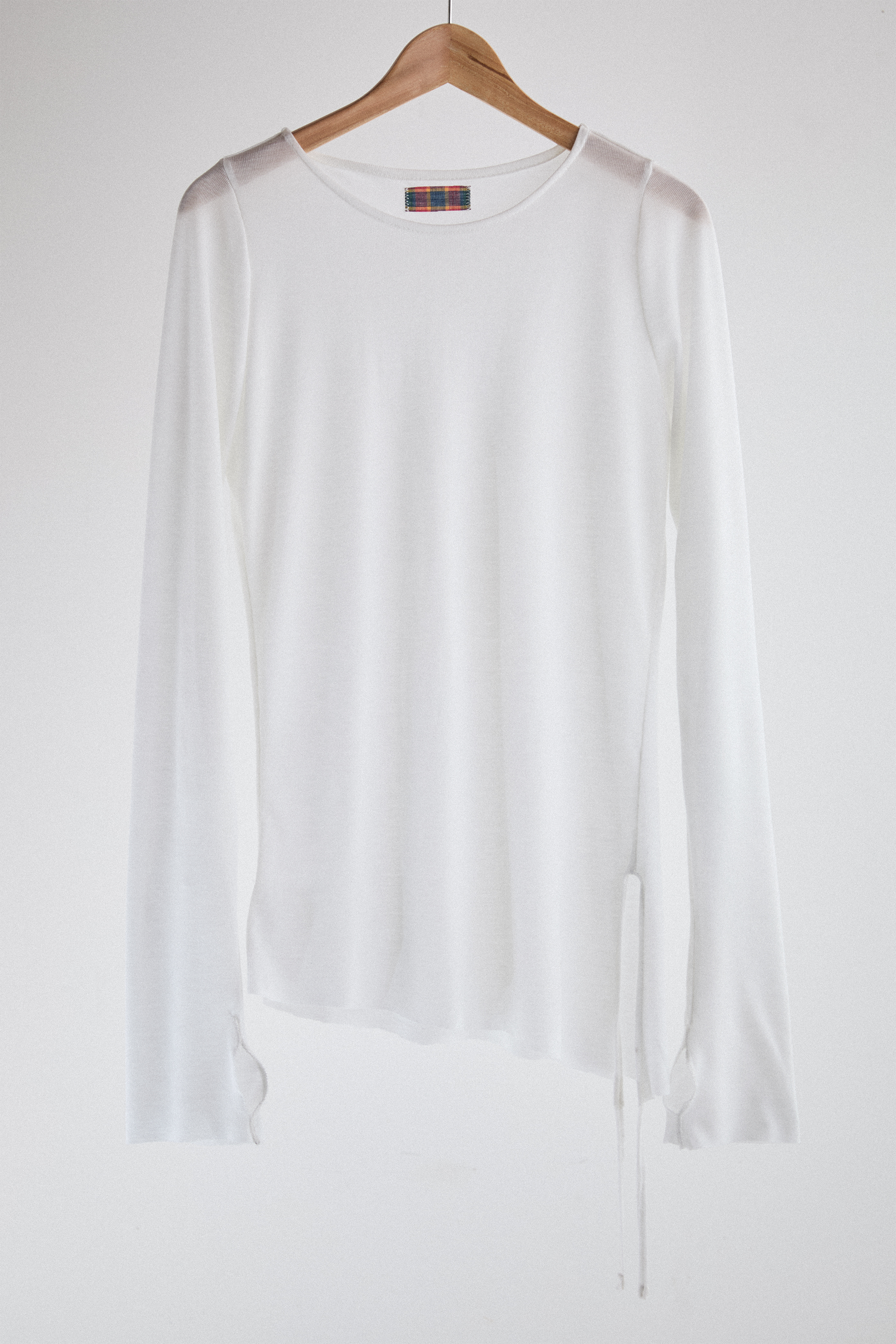 Front view of sheer long-sleeve AOA White  top.