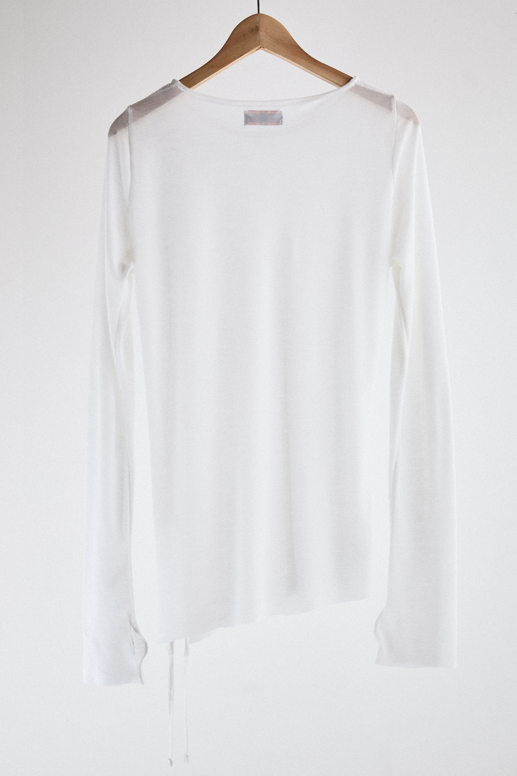 Back view of sheer long-sleeve AOA White  top.
