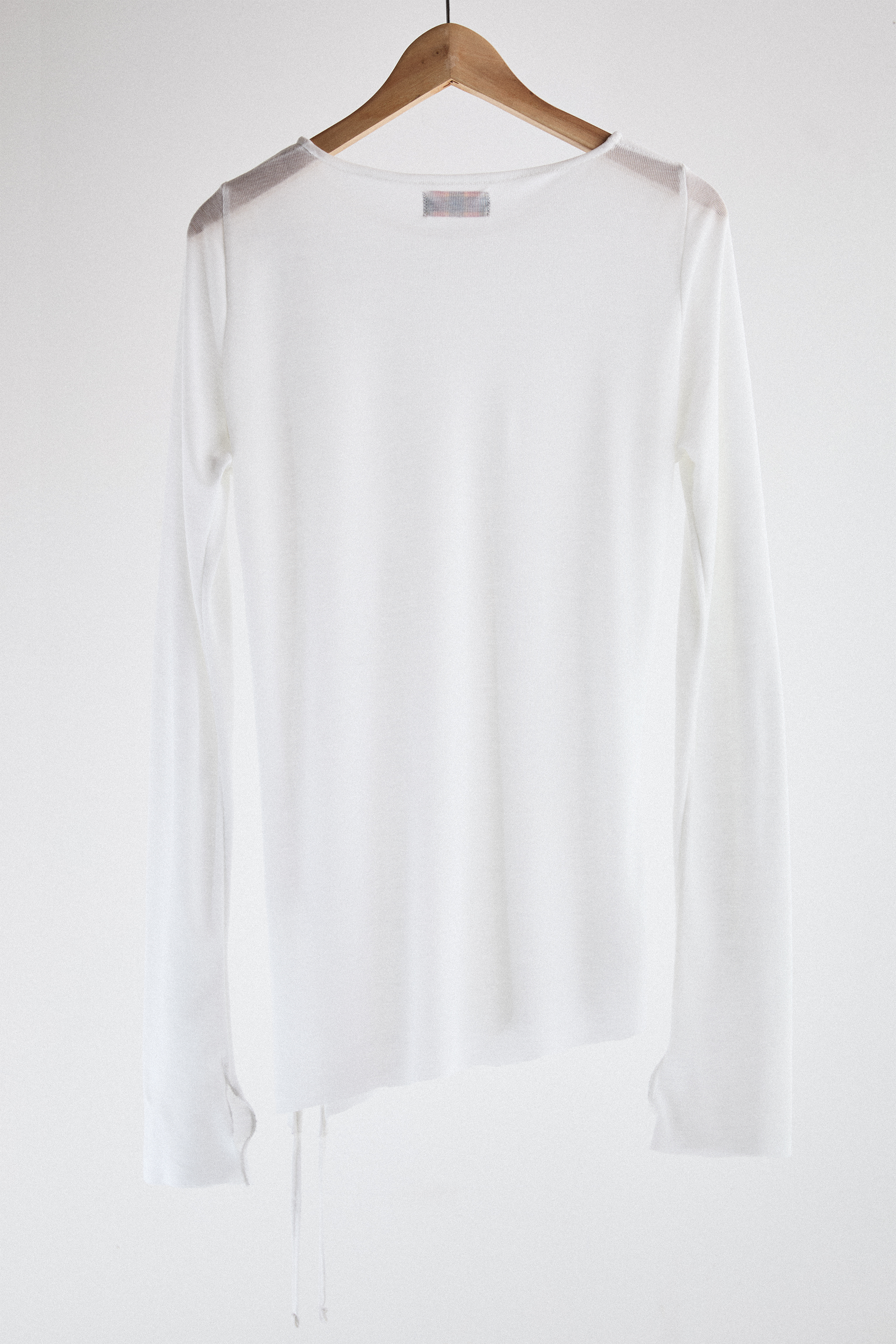 Back view of sheer long-sleeve AOA White  top.