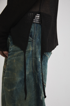 Left close-up side view of Tyler Andersen wearing sheer long-sleeve AOA Black top showing tassels.