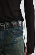 Left side front view of Tyler Andersen wearing sheer long-sleeve AOA Black top.