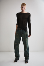 Front view of Tyler Andersen wearing sheer long-sleeve AOA Black top.