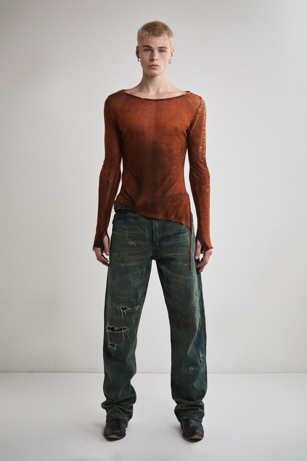 Front view of Tyler Andersen wearing sheer long-sleeve AOA rust top.