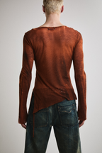 Close-up back view of Tyler Andersen wearing sheer long-sleeve AOA rust top.