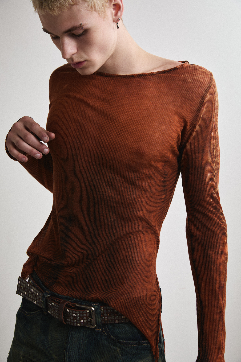 Close-up front view of Tyler Andersen wearing sheer long-sleeve AOA rust top.