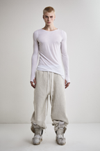 Front view of Tyler Andersen wearing sheer long-sleeve AOA White  top.